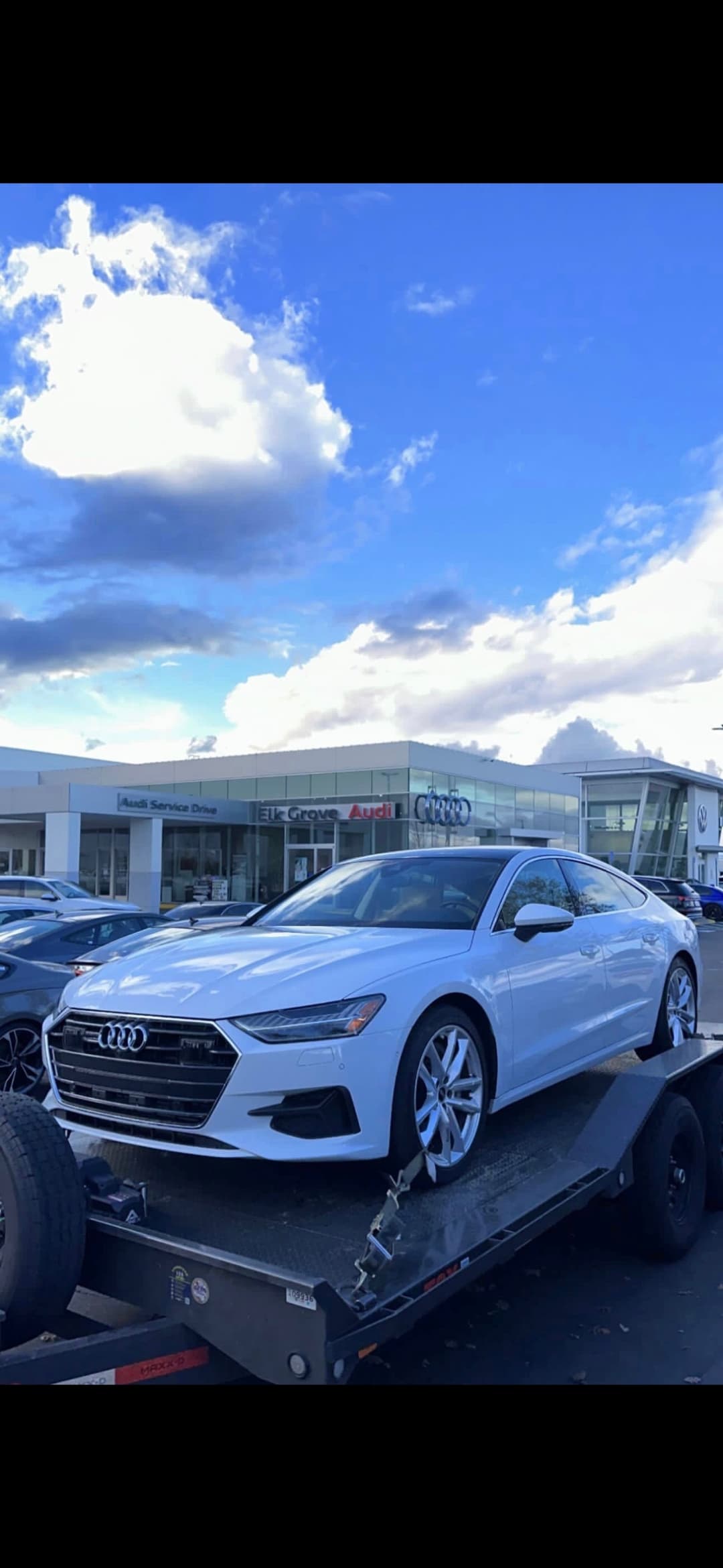 Audi sedan being towed by Mike's Tow and Transport LLC